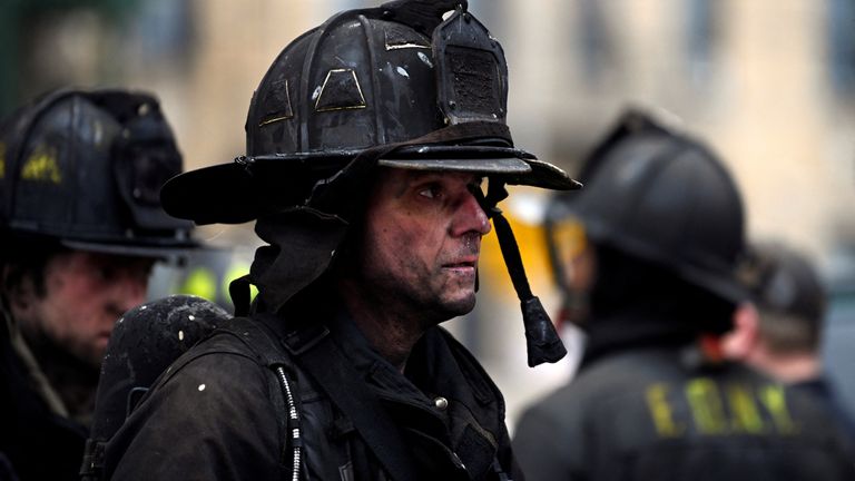 Emergency personnel from the FDNY respond to an apartment building fire in the Bronx borough of New York City, U.S., January 9, 2022. REUTERS/Lloyd Mitchell