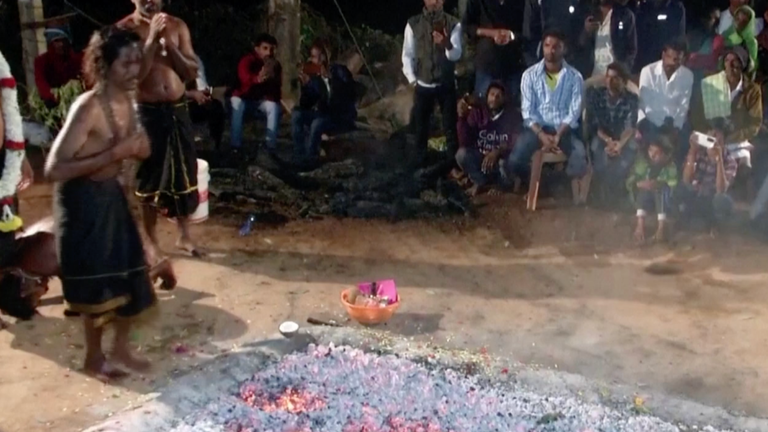 Indian devotees walk on burning embers to appease Hindu god