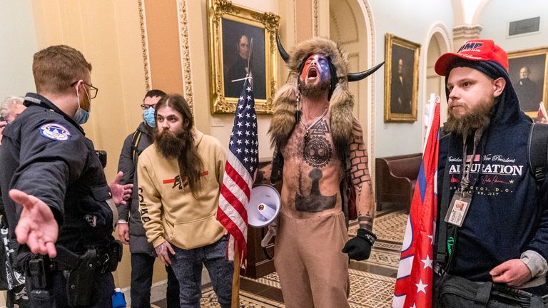 Supporters of President Donald Trump are confronted by Capitol Police officers outside the Senate Chamber inside the Capitol, Wednesday, Jan. 6, 2021 in Washington. (AP Photo/Manuel Balce Ceneta)