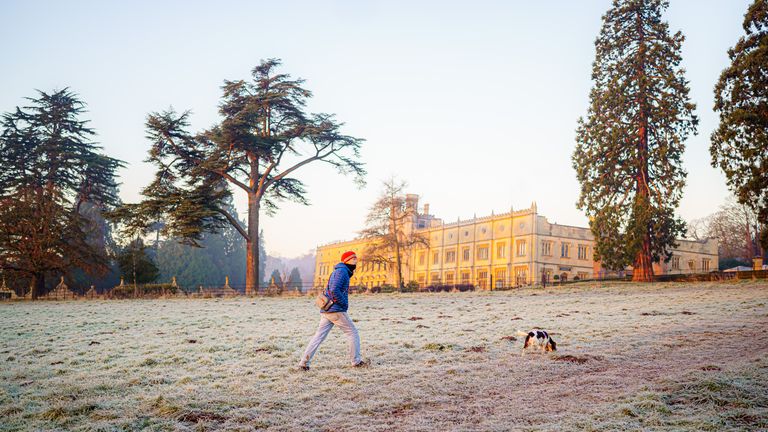A dog walker on the Ashton Court estate in Bristol on a cold and frosty morning