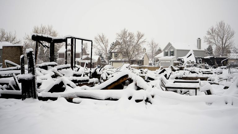 Snow covers the smouldering remains of homes in Louisville, Colorado. Pic: AP