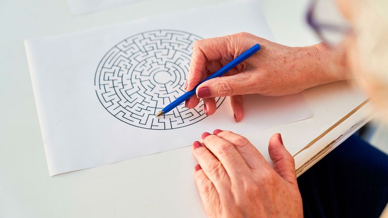 A woman solves a labyrinth puzzle as memory training