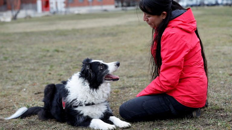Postdoctoral researcher Laura V. Cuaya talks to her dog Kun-kun, an 8-year-old Border Collie, at the Ethology Department of the Eotvos Lorand University in Budapest, Hungary, January 5, 2022. Picture taken January 5, 2022. REUTERS/Bernadett Szabo