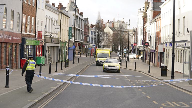 Emergency crews at the scene where a man and teenager were stabbed to death
