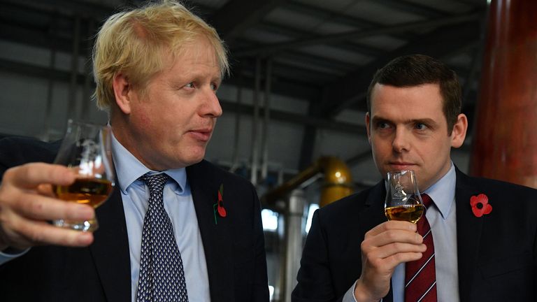 Britain&#39;s Prime Minister Boris Johnson, (L), accompanied by Conservative party candidate for Moray, Douglas Ross, tastes whisky during a general election campaign visit to Diageo&#39;s Roseisle Distillery near Elgin, Scotland, Britain November 7, 2019. Daniel Leal-Olivas/Pool via REUTERS
