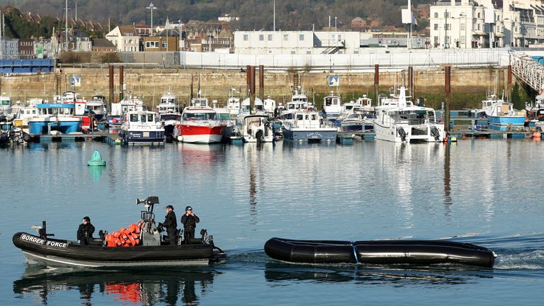 A British Border Force boat tows a dinghy used by migrants into Dover harbour, in Dover, Britain, January 14, 2022. REUTERS/Hannah McKay
