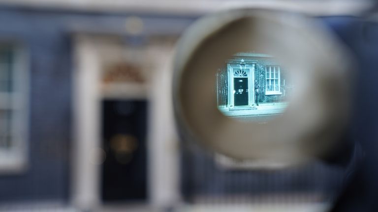 The door of the Prime Minister&#39;s official residence in Downing Street, Westminster, London, is seen through the viewfinder of a camera as public anger continues following the leak on Monday of an email from Boris Johnson&#39;s principal private secretary, Martin Reynolds, inviting 100 Downing Street staff to a "bring your own booze" party in the garden behind No 10 during England&#39;s first lockdown on May 20, 2020. Picture date: Wednesday January 12, 2022.

