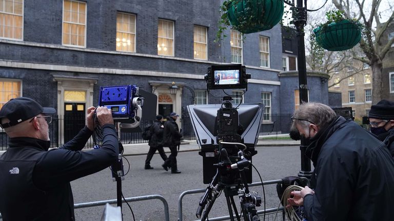 Armed police officers walk past the media gathered outside 10 Downing Street, London, as Prime Minister Boris Johnson faces fresh allegations of breaking coronavirus rules after Downing Street admitted he had a birthday celebration inside No 10 during the first lockdown. Picture date: Tuesday January 25, 2022.