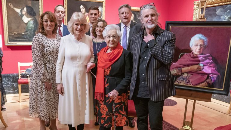 The Duchess of Cornwall with Holocaust survivor Helen Aronson (centre) and her family, and artist Paul Benney (right) beside the portrait of Helen during an exhibition at The Queen&#39;s Gallery, Buckingham Palace, London, of &#39;Seven Portraits: Surviving the Holocaust&#39;, which were commissioned by the Prince of Wales to pay tribute to Holocaust survivors. Picture date: Monday January 24, 2022.