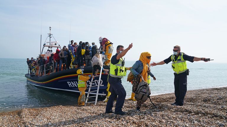 ile photo dated 06/09/21 of a group of people thought to be migrants being brought ashore from the local lifeboat at Dungeness in Kent, after being picked-up in the Channel. More than 28,300 people crossed the English Channel to the UK aboard small boats in 2021, triple the number for 2020. Issue date: Tuesday January 4, 2022.