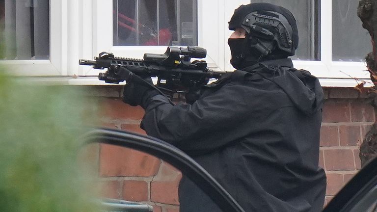 Armed police officers outside a property in Earlsdon Avenue North, Coventry, where police remain in a stand-off with a man. Officers from West Midlands Police were called to the property on Sunday to carry out a welfare check on a man and child, who are both believed to still be inside the property. Picture date: Tuesday January 11, 2022.
