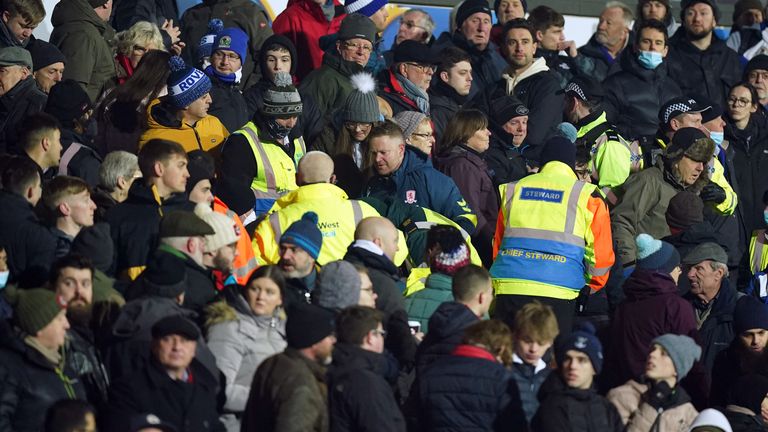 Middlesbrough players wait as play is paused due to a medical emergency in the stands during the Sky Bet Championship match at Ewood Park, Blackburn. Picture date: Monday January 24, 2022.
