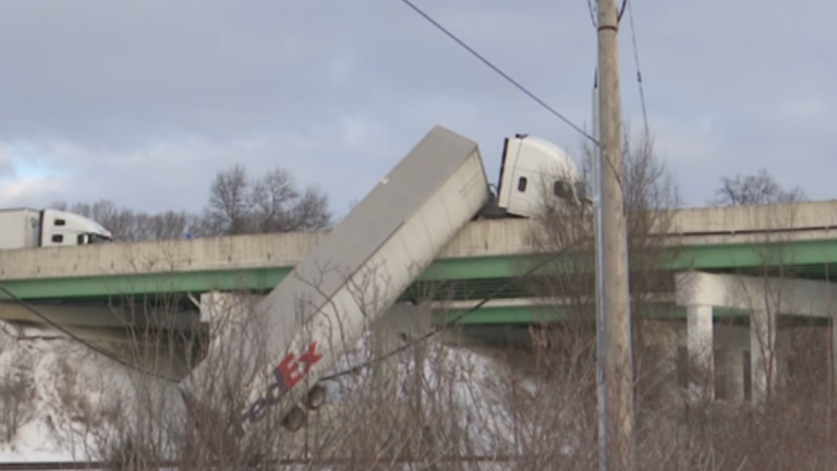 Truck dangles from Indiana overpass
