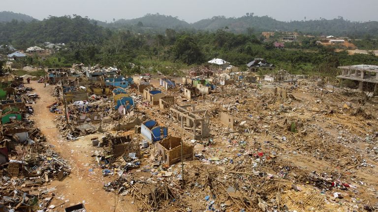 A view shows debris of houses and other buildings that were destroyed when a vehicle carrying mining explosives detonated along a road in Apiate, Ghana, January 21, 2022. Picture taken with a drone. REUTERS/Cooper Inveen