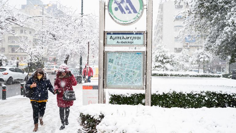 24 January 2022, Greece, Athen: People walk past a metro station during snowfall. Heavy snowfall caused problems on Monday, especially in central and southern Greece. In many regions, the Greek Civil Defense sent warning text messages to residents and called on them not to leave the house if possible. Photo by: Angelos Tzortzinis/picture-alliance/dpa/AP Images
PIC:AP

