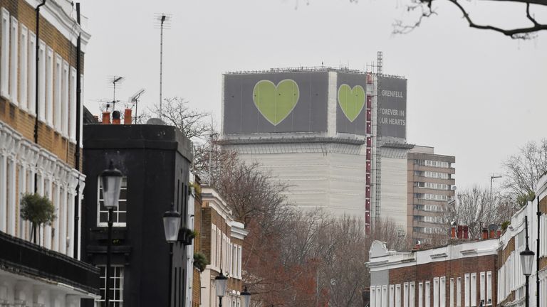 A message is seen on the covered remains of the Grenfell Tower, after it was announced Britain&#39;s government will seek an extra 4 billion pounds ($5.4 billion) from property developers to fund repairs to dangerous apartment blocks, in the wake of a fire that killed more than 70 people at Grenfell in 2017, in London, Britain, January 10, 2022. REUTERS/Toby Melville
