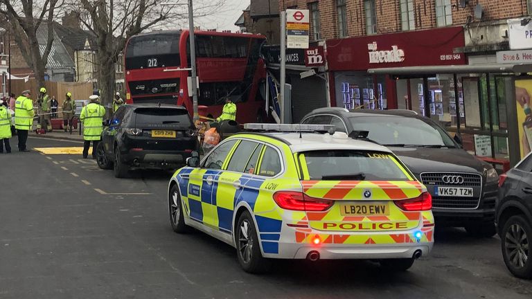 Emergency services at the scene on The Broadway in Highams Park, east London, where a number of people are being treated by paramedics from the London Ambulance Service after a bus collided with a building. Picture date: Tuesday January 25, 2022.
