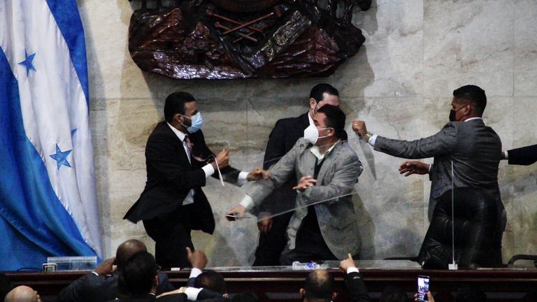 Lawmaker of the Liberty and Refoundation Party (LIBRE) Rasel Thome tries to assault Jorge Calix, a dissident lawmaker of his party after being proposed as provisional president, which resulted in a brawl among lawmakers of the LIBRE party, at the Congress building in Tegucigalpa, Honduras January 21, 2022. REUTERS/Fredy Rodriguez