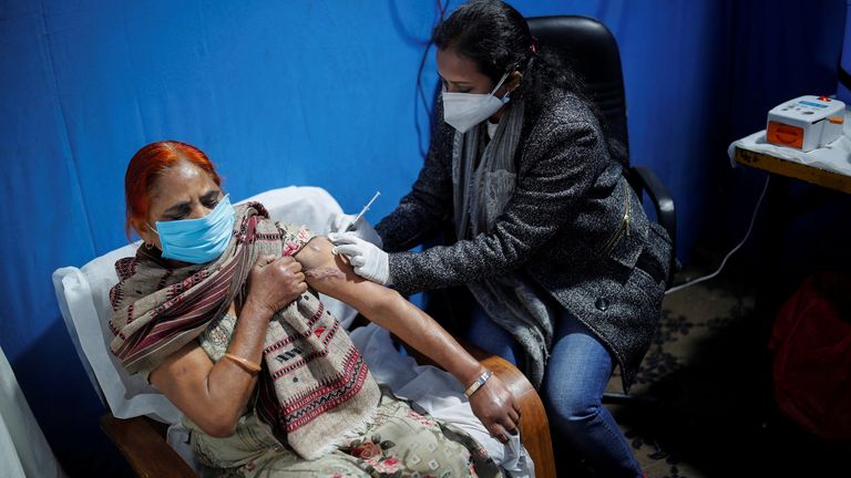 A woman receives a booster dose of Covaxin in New Delhi