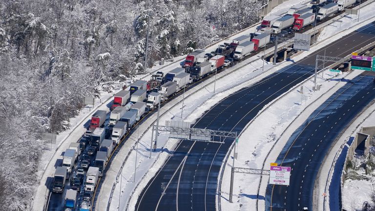 Cars and trucks are stranded on sections of Interstate 95 Tuesday Jan. 4, 2022, near Quantico, Va. Close to 48 miles of the Interstate was closed due to ice and snow. (AP Photo/Steve Helber)   