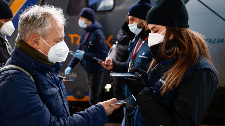 A man shows his coronavirus disease (COVID-19) "Super Green Pass" before getting on a train on the day Italy brings in tougher rules for the unvaccinated, at Termini main train station in Rome, Italy, January 10, 2022