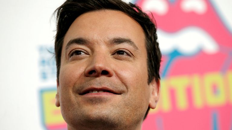 Actor and television host Jimmy Fallon poses for photographers as he arrives for the opening of the new exhibit 