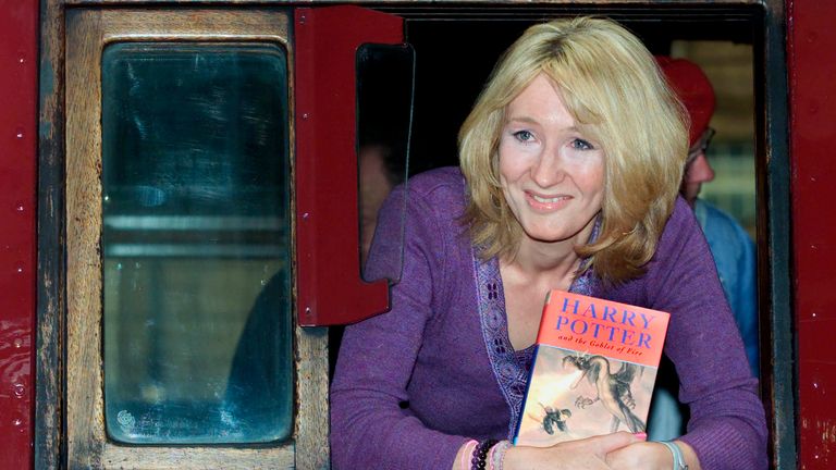 JK Rowling leaned out of the Hogwarts Express steam train at King's Cross Station in London in July 2000 and has the fourth book in the Harry Potter series, Harry Potter and the Goblet of Fire. Pic: AP