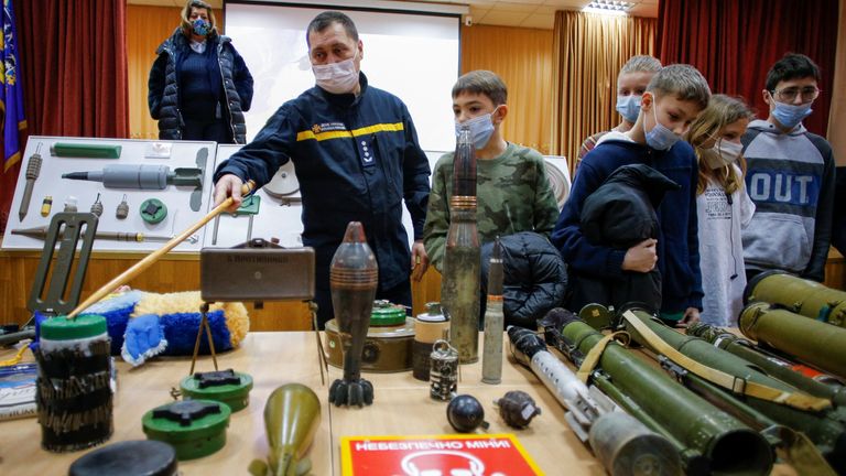 A sapper of Ukraine&#39;s State Emergency Service shows mockups of improvised explosive devices to students during bomb threat training at a local school following a recent spate of hoax bomb threats in public institutions in Kyiv, Ukraine January 27, 2022. REUTERS/Valentyn Ogirenko
