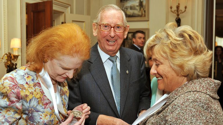 Lord Sainsbury laughs as Dr Carol Hogel CBE (left) and Dame Vivien Duffield CBE, study their Prince of Wales Medals for Arts Philanthropy at Clarence House in central London