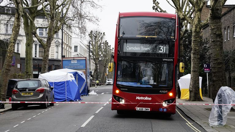 Forensic tents (left) at the scene on Chippenham Road, Maida Vale, west London, where a woman has been stabbed to death and a man killed after being hit by a car. The woman was stabbed in Chippenham Road at around 9am and officers called to the scene also found a man who had been hit by a car. Both victims were pronounced dead. Picture date: Monday January 24, 2022.