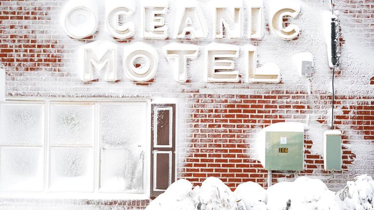 Signage outside of a motel is covered in snow, Saturday, Jan. 29, 2022, in Ocean City, Md. A powerful nor&#39;easter swept up the East Coast on Saturday, threatening to bury parts of 10 states under deep, furiously falling snow accompanied by coastal flooding and high winds that could cut power and leave people shivering in the cold weather expected to follow. (AP Photo/Julio Cortez).