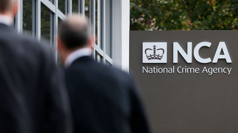 Pedestrians walk past the National Crime Agency (NCA) headquarters in London October 7, 2013. The new body has been launched to pursue organised criminals. REUTERS/Stefan Wermuth (BRITAIN - Tags: POLITICS CRIME LAW)
