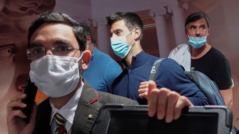Serbian tennis player Novak Djokovic walks with his team after landing at Dubai Airport after the Australian Federal Court upheld a government decision to cancel his visa to play in the Australian Open, in Dubai, United Arab Emirates, January 17, 2022. REUTERS/Loren Elliott TPX IMAGES OF THE DAY