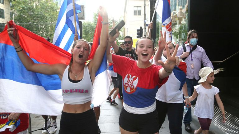 Fans of Serbian Novak Djokovic react to news of his victory on the pitch and walk to Federation Square ahead of the Australian Open in Melbourne, Australia on Monday, January 10, 2022. (AP Photo / Hamish Blair) PIC: AP