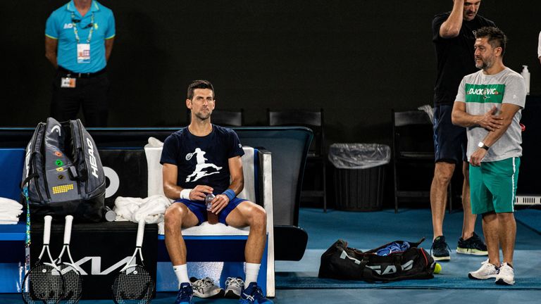 Serbian tennis player Novak Djokovic rests during a training session at Melbourne Park as questions remain over the legal battle regarding his visa to play in the Australian Open in Melbourne, Australia, January 14, 2022. 
