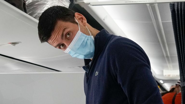 Novak Djokovic prepares to take his seat on a plane to Belgrade, in Dubai, United Arab Emirates, Monday, Jan. 17, 2022. Djokovic was deported from Australia on Sunday after losing a bid to stay in the country to defend his Australian Open title despite not being vaccinated against COVID-19.(AP Photo/Darko Bandic)
