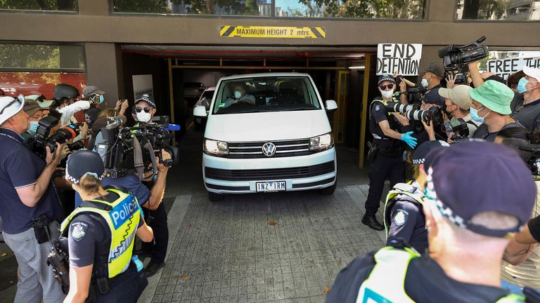 Members of the media waiting for a sighting of Serbian tennis player Novak Djokovic surround a departing transport vehicle exiting the Park Hotel, where the athlete has been held during a legal challenge over his visa, in Melbourne, Australia, January 10, 2022. REUTERS/Asanka Brendon Ratnayake  REFILE - QUALITY REPEAT