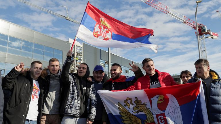 Fans of Serbian tennis player Novak Djokovic hold Serbian flags as they wait for his arrival at Nikola Tesla Airport, after the Australian Federal Court upheld a government decision to cancel his visa to play in the Australian Open, in Belgrade, Serbia, January 17, 2022. REUTERS/Marko Djurica

