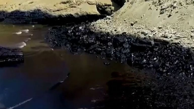 Beach is turned black in Peru after oil spill