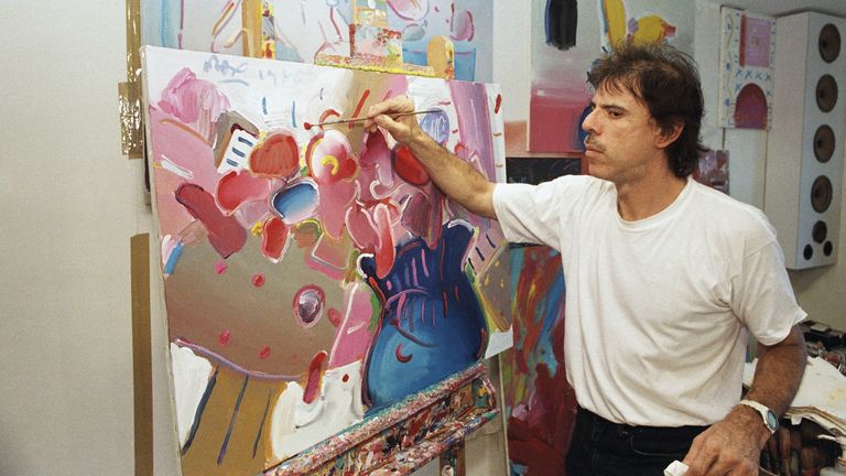 Artist Peter Max poses at his studio in New York City in July 1986. Pic: AP


