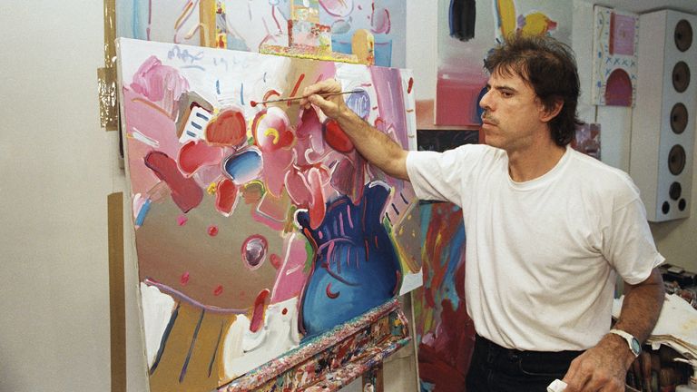 Artist Peter Max poses at his studio in New York City in July 1986. Pic: AP 