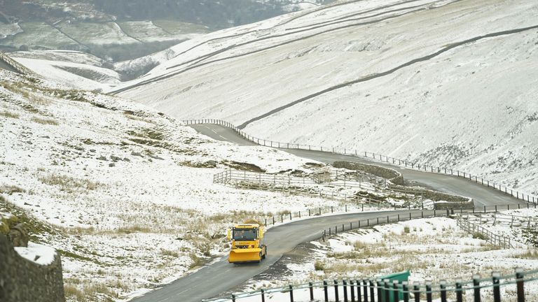 A snow plough and gritting vehicle drives along the snow lined Buttertubs Pass near Hawes in the Yorkshire Dales. Weather forecasters are predicting fresh falls later in the morning across the north of England. Picture date: Thursday January 6, 2022.