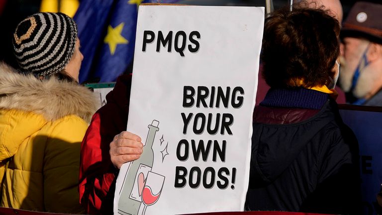 Pic: AP

Protestors hold placards in Parliament Square as Britain...s Prime Minister Boris Johnson attends the weekly Prime Ministers&#39; Questions session in parliament in London, Wednesday, Jan. 12, 2022.(AP Photo/Frank Augstein)