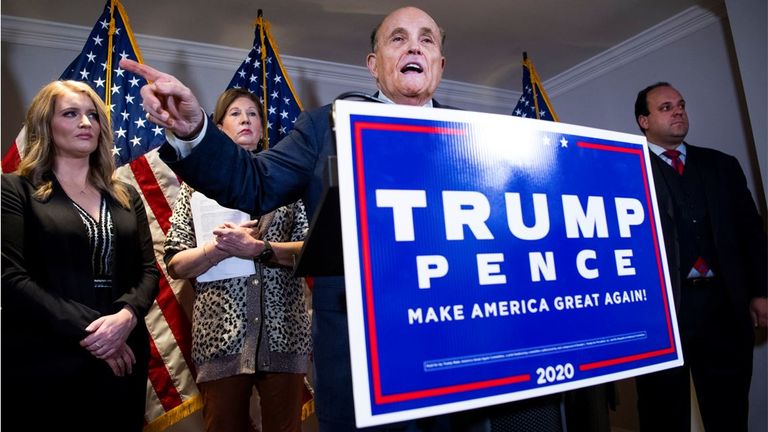 Rudy Giuliani holds a news conference on lawsuits regarding the outcome of the 2020 presidential election on 19 November 2020 with Jenna Ellis (far left), Sidney Powell and Boris Epshteyn. Pic: AP