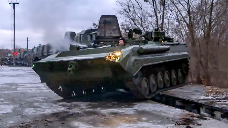 A Russian armoured vehicle is driven off a railway platform after arriving in Belarus. Pic: AP