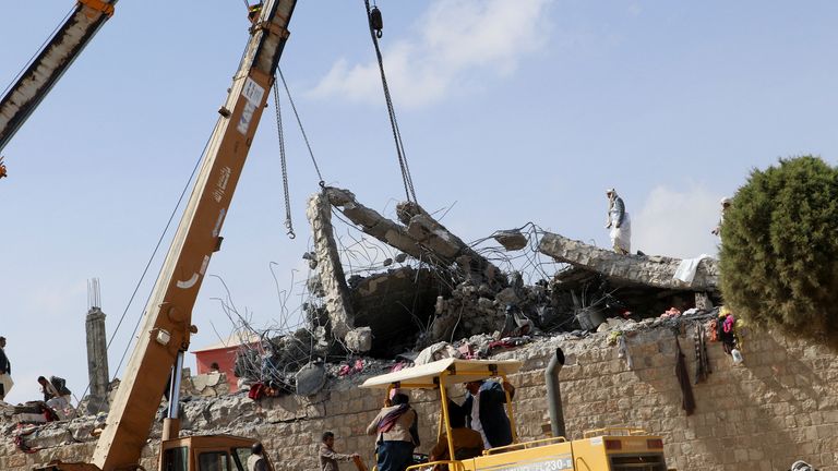 Rescuers use cranes to lift the collapsed roof of a detention center hit by air strikes, in Saada, Yemen Jaunary 21, 2022. REUTERS/Naif Rahma
