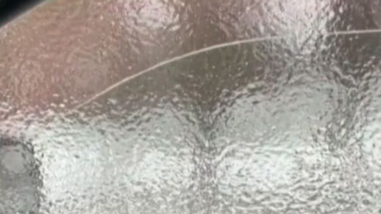 Sheet ice forms over car window in New York