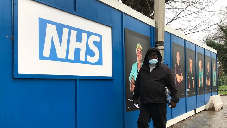 A pedestrian passes a COVID testing facility that has been set up at St.George&#39;s Hospital in London, Tuesday, Jan. 4, 2022. The NHS is expected to come under increasing pressure over the next few weeks from the Omicrom virus variant. (AP Photo/Kirsty Wigglesworth)


