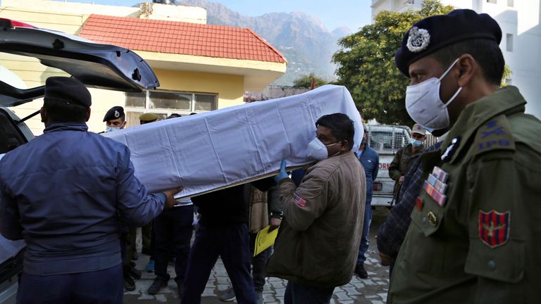 Health worker carries and load coffin of a victim of a stampede at hospital in Katra, India, Jan.1, 2022.  Pic: AP (AP Photo/Channi Anand)