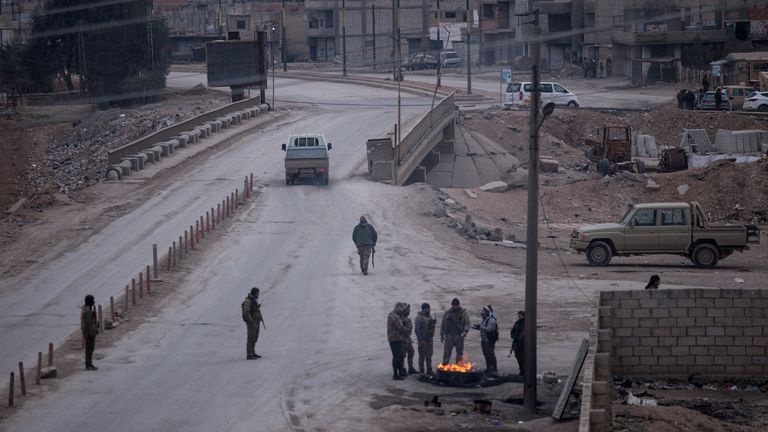 Fighters with the Kurdish-led Syrian Democratic Forces man a checkpoint in Hassakeh, northeast Syria, Monday, Jan. 24, 2022.Clashes between U.S.-backed Syrian Kurdish fighters and militants continued for a fourth day Sunday near the prison in northeastern Syria that houses thousands of members of IS, the Kurdish force said. (AP Photo/Baderkhan Ahmad)